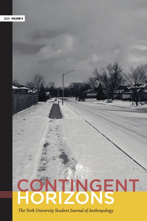 Gray-scale image of a sidewalk in a suburban neighbourhood. There is snow on the ground and road those the sidewalk has been partially cleared.